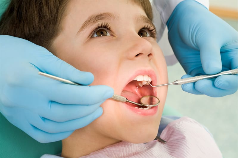 Boy in dentist chair getting dental checkup