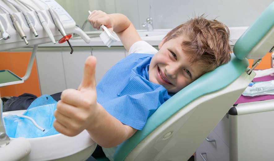 Boy giving thumbs up at the dentist