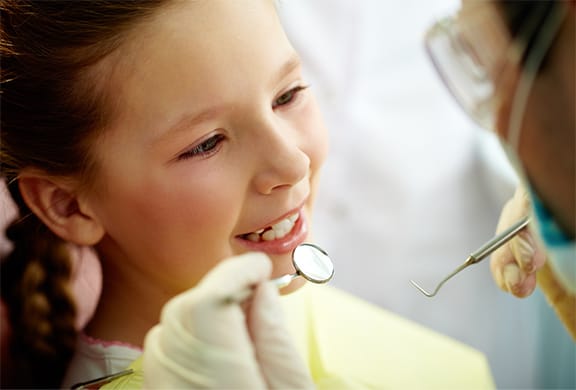Dentist checking out child